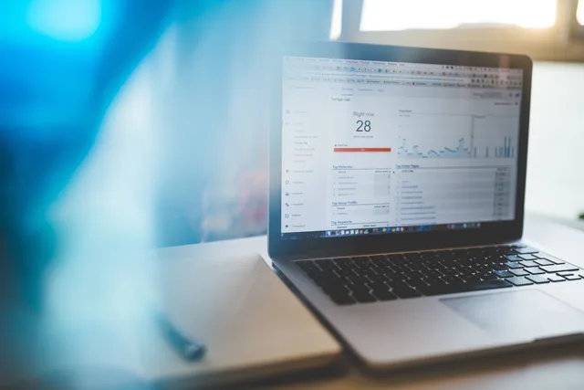 Laptop displaying Google Analytics in a modern workspace, highlighting digital analytics and technology. Affiliate program best practices for digital products: disclosure, data and payout controls